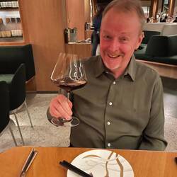Happy man with a glass of Beaujolais