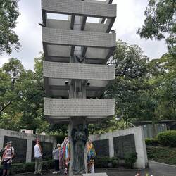 Hiroshima Memorial Tower to the Mobilized Students. Note the colourful chains of Origami Cranes