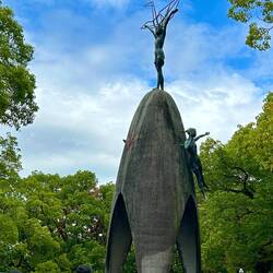 Memorial to the children with child holding a crane overhead.