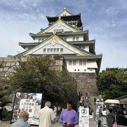 View of iconic Osaka Castle from surrounding gardens.
