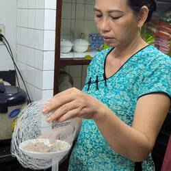 The wife making rice paper spring roles