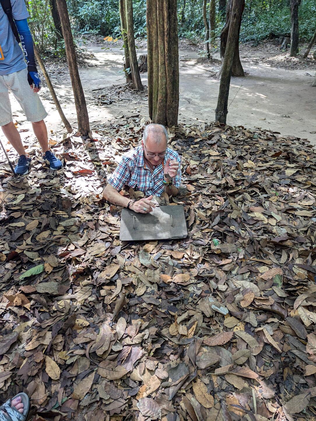 Going down into a tiny, camouflaged entrance.