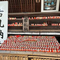 This shine sells fortunes in these small wooden dolls, and vistors then place them somewhere