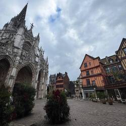 Saint Maclou and wooded sided homes beside it