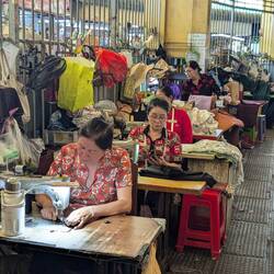 Machinists at the edge of the fabric and tailoring stalls