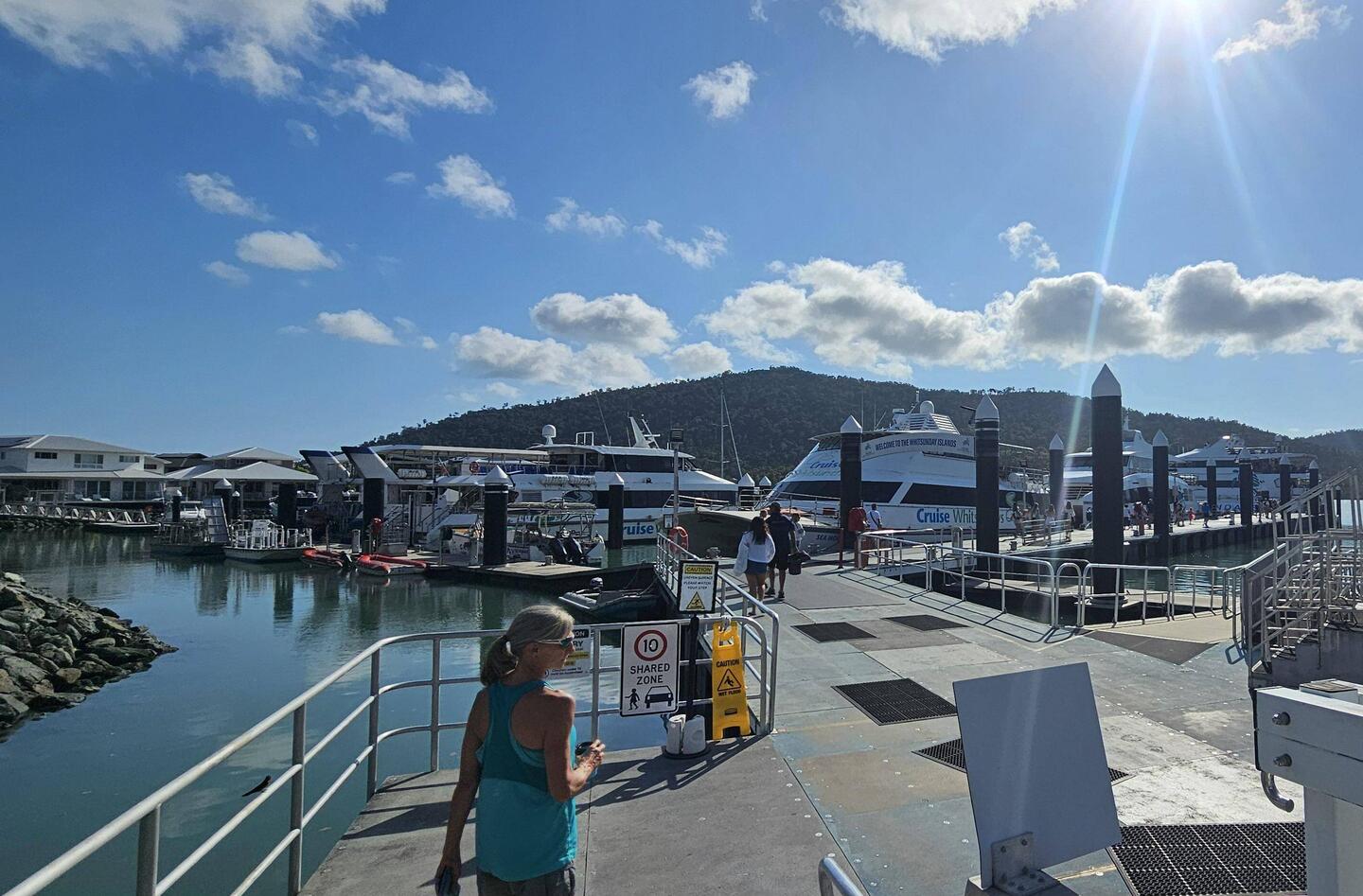 8a: Coffee in hand, heading to the ferry at Port of Airlie.