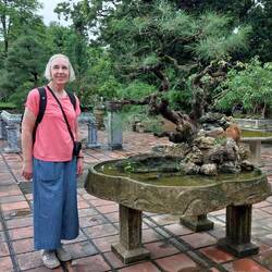 Helen by a Bonsai tree in the garden