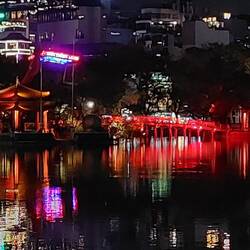 The Jade Mountain Temple (Den Ngoc Son) is reached by the red Huc Bridge