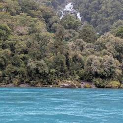 Blue water in the river everywhere with waterfalls in the background