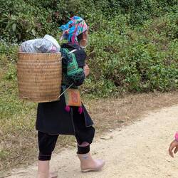 Local woman carrying her handcraft products to sell