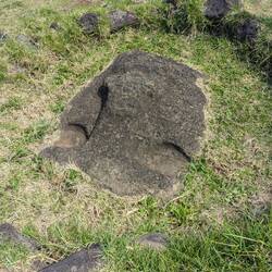 A moai head engulfed by the ground