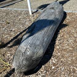 Seal face carved into driftwood log