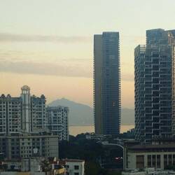 Sunset view from Madeleine's apartment with Hong Kong hills across the bay.