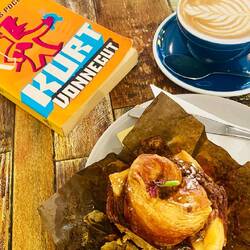 flat white and cinnamon croissant roll and more vonnegut