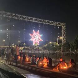 Lighting candles for Night of the Little Candles (there are hundreds of them all over the city)