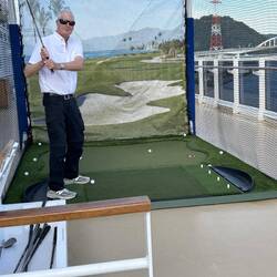 Don in golf practice cage.