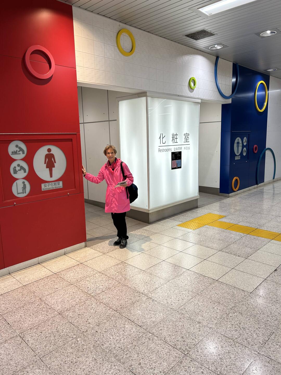 Lee outside an inside public washroom.