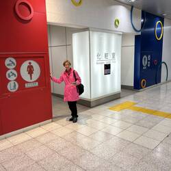 Lee outside an inside public washroom.
