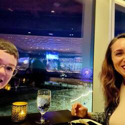 Mommy and son date having tapas with the beach boardwalk backdrop