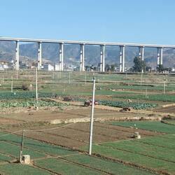 View from train of via duct highway - road & railways tunnel through hills and fly over valleys PRC