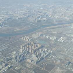 Approaching X'ian airport miles out from the old walled city. Note piles of high rise housing.