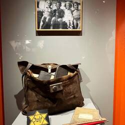 The little Jewish boy in the photo's school case. He didn't survive