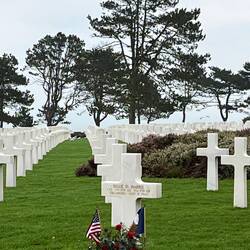 Grave with the Omaha beach sand stubbed in to the name plate