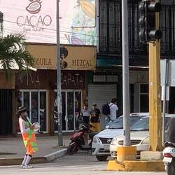 Strange bloke 'entertaining' traffic with drumming and jigging.