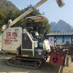 A vintage agricultural machine blow the picture to see who's face is featured.