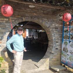 David at a quaint entrance to an eatery