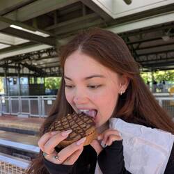 Lara taking a brownie cookie very seriously