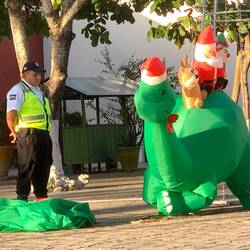 Local bobby 'working hard' watching an inflatable Christmas toy inflate.