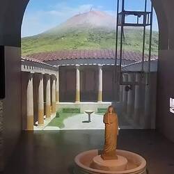 A video representation of Visuvius erupting on 24 October 79AD incasing Pompei in lava and dust.