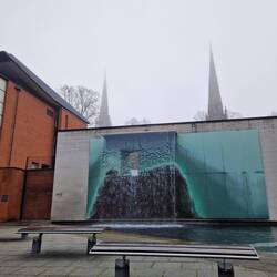 The Waterwindow art work in the priory area. The steeples of the old cathedral and Holy Trinity