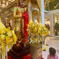 Little girl eyeing display at mall entrance in Bangkok
