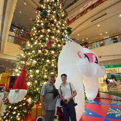 Roel and Title in front of huge Christmas tree, inside was a photo area