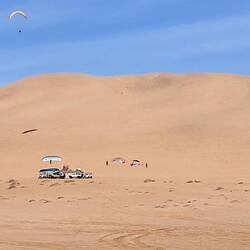 Para sailing off the dunes.