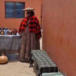 The traditional dress of a Herero woman with the hat symbolising cow horns.