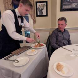 Almost over the top French service. Meals would be plated simultaneously by one waiter per person.