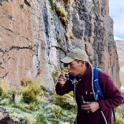 Roly demonstrating how to pay respect to Pachamama by drinking wine and sharing it with earth/water