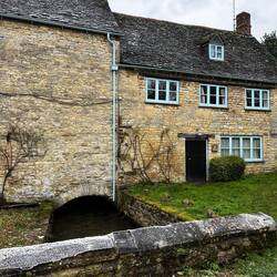The old mill house across a diverted part of the stream