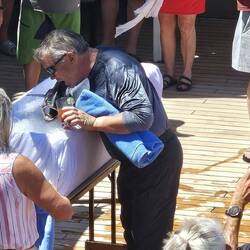 Chris kisses the fish as part of the initiation -- he is now officially a Shellback!