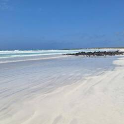 A huge expanse of white sand and no shade.