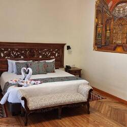 The room is spacious and has a beautiful original wooden floor.