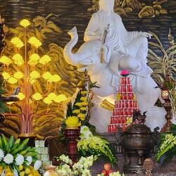 Quanyin atop an elephant, surrounded by offerings and ornate decorations