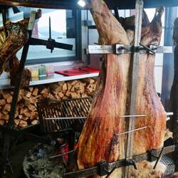 Lamb carcasses roasted for four hours over open flames