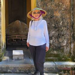 Cathy exploring Hue (giant turtle in background)