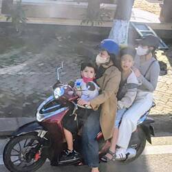 Typical family on a small motorcycle