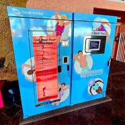 Pool towel with microchip dispensing macine