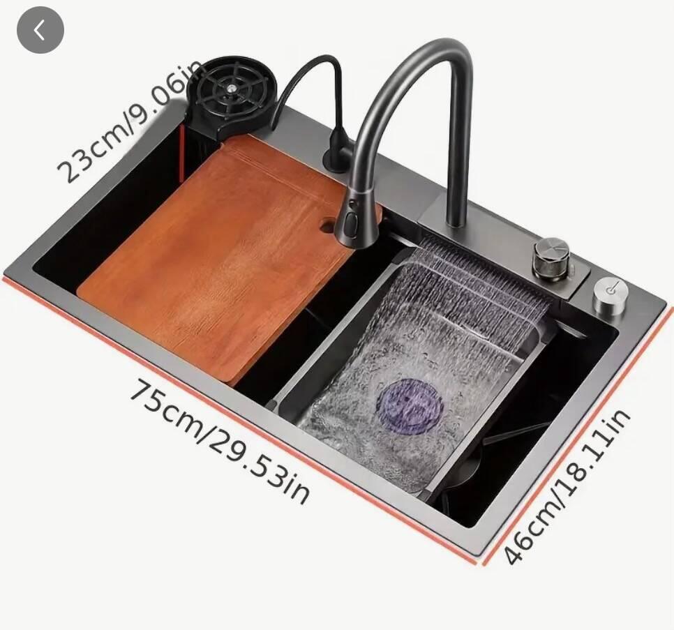 Kitchen sink with cup rinsing, cutting board, and waterfall spray for washing veggies.